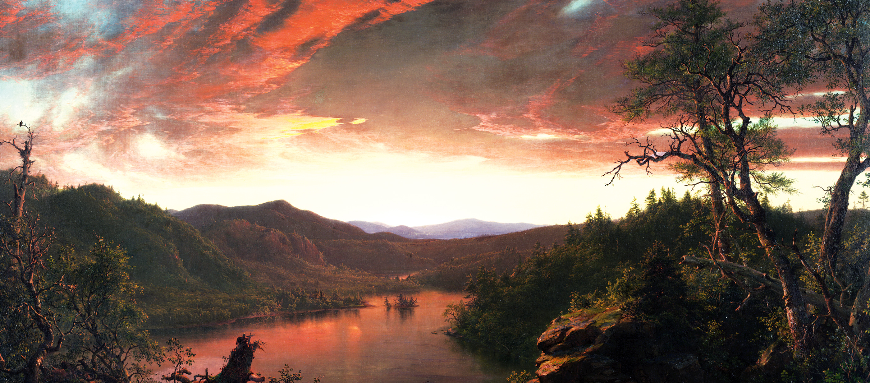 A vast wilderness beneath a dramatic red twilight sky